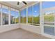 Enclosed patio surrounded by windows with a view of private backyard and greenery at 10927 Se 168Th Loop, Summerfield, FL 34491
