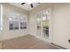 Covered patio with neutral walls, tile flooring, and access from the dining area through glass sliding doors at 10927 Se 168Th Loop, Summerfield, FL 34491