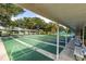 Outdoor shuffleboard courts with covered seating, lush trees, and well-maintained surroundings at 10927 Se 168Th Loop, Summerfield, FL 34491