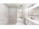 Elegant bathroom, featuring a marble shower and modern white vanity at 11 Emerald Trl, Ocala, FL 34472