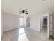 Spacious bedroom with ceiling fan and access to a bathroom and hallway at 11 Emerald Trl, Ocala, FL 34472