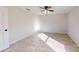 Light-filled bedroom featuring wood-look tile floors and a ceiling fan at 11 Emerald Trl, Ocala, FL 34472
