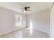 Well-lit bedroom with ceiling fan and large window at 11 Emerald Trl, Ocala, FL 34472