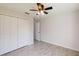 Bright bedroom with double doors and wood-look tile flooring at 11 Emerald Trl, Ocala, FL 34472