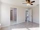 Bedroom with wood-look tile floors, en-suite bathroom, and walk-in closet at 11 Emerald Trl, Ocala, FL 34472