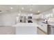 Modern kitchen with white cabinets, stainless steel appliances, and an island at 11 Emerald Trl, Ocala, FL 34472