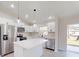 Modern kitchen with island, stainless steel appliances, and backyard access at 11 Emerald Trl, Ocala, FL 34472