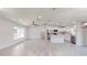 Open-concept living and kitchen area with wood-look tile floors at 11 Emerald Trl, Ocala, FL 34472