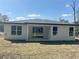 Back of a modern home with a covered patio and a spacious backyard, great for outdoor living at 14711 Sw 69Th Court Rd, Ocala, FL 34473