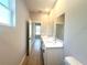 Bathroom featuring double vanity, quartz countertop, and wood-look tile flooring at 14711 Sw 69Th Court Rd, Ocala, FL 34473