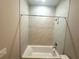 Bathroom features a bathtub and shower with tiled walls and modern fixtures at 14711 Sw 69Th Court Rd, Ocala, FL 34473