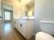 Bathroom with a double vanity, quartz countertop, and wood-look tile flooring at 14711 Sw 69Th Court Rd, Ocala, FL 34473