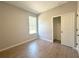 Bedroom with closet and window showcasing wood-look tile flooring at 14711 Sw 69Th Court Rd, Ocala, FL 34473