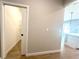 View of a walk-in closet with shelving and a glimpse of the open concept living space at 14711 Sw 69Th Court Rd, Ocala, FL 34473