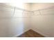 Walk-in closet features wire shelving and wood-look tile flooring at 14711 Sw 69Th Court Rd, Ocala, FL 34473