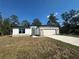 Charming single-story home with stone accents, a two-car garage and a well-manicured lawn at 14711 Sw 69Th Court Rd, Ocala, FL 34473