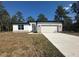 Charming single-story home with stone accents, a two-car garage and a well-manicured lawn at 14711 Sw 69Th Court Rd, Ocala, FL 34473