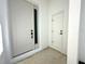 View of the sleek, white front door with black hardware and sidelight at 14711 Sw 69Th Court Rd, Ocala, FL 34473