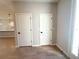 Hallway with neutral paint and two white doors, one leading to a bright, airy space at 14711 Sw 69Th Court Rd, Ocala, FL 34473