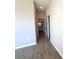 Hallway featuring wood-look tile flooring and leading to a bathroom at 14711 Sw 69Th Court Rd, Ocala, FL 34473