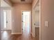 Hallway featuring wood-look tile flooring, neutral paint, and white doors at 14711 Sw 69Th Court Rd, Ocala, FL 34473