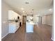 Open-concept kitchen with white cabinets, quartz countertops, and an island at 14711 Sw 69Th Court Rd, Ocala, FL 34473