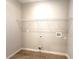 A bright laundry room with tile flooring and a wire rack at 14711 Sw 69Th Court Rd, Ocala, FL 34473