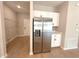 Laundry area with stainless steel refrigerator, shelving, and white cabinetry at 14711 Sw 69Th Court Rd, Ocala, FL 34473
