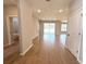 Bright living room featuring wood-look tile flooring and sliding glass doors leading to the backyard at 14711 Sw 69Th Court Rd, Ocala, FL 34473