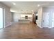 Open-concept living room with wood-look tile flooring and view of kitchen at 14711 Sw 69Th Court Rd, Ocala, FL 34473