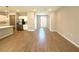 Open concept living area with wood-look tile floors, white cabinets, and stainless steel refrigerator at 14711 Sw 69Th Court Rd, Ocala, FL 34473