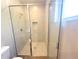 Tiled walk-in shower featuring a glass door and built in shelf niche at 14711 Sw 69Th Court Rd, Ocala, FL 34473
