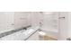 Well-lit bathroom featuring granite countertops, a modern sink, and a shower-tub combination at 21114 Sw Peach Blossom St, Dunnellon, FL 34431