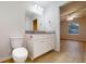 Fresh bathroom with granite counters, white cabinets, and hardwood flooring at 21114 Sw Peach Blossom St, Dunnellon, FL 34431