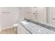 Bathroom featuring a granite countertop vanity and shower at 21114 Sw Peach Blossom St, Dunnellon, FL 34431