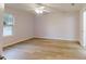 Spacious bedroom featuring hardwood flooring, ample natural light and a ceiling fan at 21114 Sw Peach Blossom St, Dunnellon, FL 34431