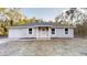 Charming single-story home with a well-maintained front yard and a classic white entryway at 21114 Sw Peach Blossom St, Dunnellon, FL 34431