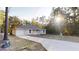 Well-maintained front exterior with a lush green lawn and extended driveway at 21114 Sw Peach Blossom St, Dunnellon, FL 34431
