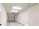 Empty two-car garage features a functional garage door and overhead lighting at 21114 Sw Peach Blossom St, Dunnellon, FL 34431