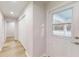 Hallway and entryway features white trim, light hardwood floors, and a convenient coat closet at 21114 Sw Peach Blossom St, Dunnellon, FL 34431