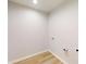 Bright laundry room with wood-look floors and washer/dryer hookups at 21114 Sw Peach Blossom St, Dunnellon, FL 34431