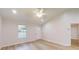 Inviting living room featuring light wood flooring, a ceiling fan, and lots of natural light at 21114 Sw Peach Blossom St, Dunnellon, FL 34431