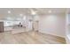 Bright, open-concept living space featuring light wood floors and access to the modern kitchen at 21114 Sw Peach Blossom St, Dunnellon, FL 34431