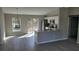 Inviting living room and kitchen area featuring modern gray flooring and stainless steel appliances at 22084 Sw Rainbow Lakes Blvd, Dunnellon, FL 34431