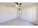 Well-lit bedroom with ceiling fan and double-door closet at 227 Oak Lane Cir, Ocala, FL 34472