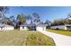 Newly constructed home with a gray exterior, driveway, and well-manicured lawn at 227 Oak Lane Cir, Ocala, FL 34472