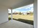 View of the backyard featuring a grass lawn from the covered patio at 2647 Sw 154Th Ln, Ocala, FL 34473