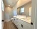 Modern bathroom features a double vanity, large mirror, and a glass-enclosed shower at 2647 Sw 154Th Ln, Ocala, FL 34473