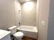 Bathroom showcasing a tub with tiled walls and wood-look tile floors and neutral colored walls at 2647 Sw 154Th Ln, Ocala, FL 34473