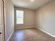 Neutral bedroom with wood-look tile flooring, window with outside view, and white trim at 2647 Sw 154Th Ln, Ocala, FL 34473